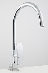 Modern steel faucets, for the kitchen sink. Isolated on white background.