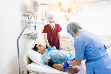 Obraz premium Doctors give resuscitation to a male patient in the emergency room. Cardiac massage