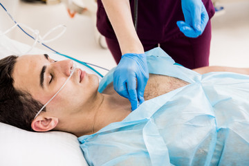 Doctors give resuscitation to a male patient in the emergency room. Cardiac massage