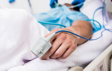 Fototapeta premium Doctors give resuscitation to a male patient in the emergency room. Cardiac massage