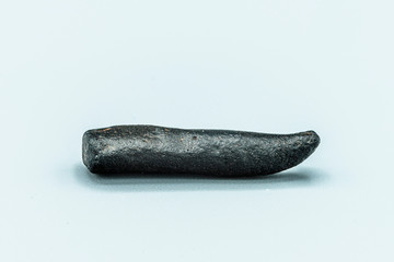 Black magnetic Tektite Meteorite isolated, piece of rock formed in big meteorite collision at...