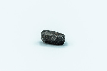 Black magnetic Tektite Meteorite isolated, piece of rock formed in big meteorite collision at...