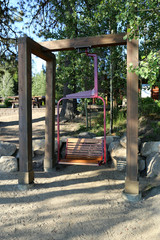 Fototapeta na wymiar Park swing made with a ski lift chair