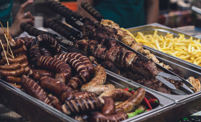 Assorted meat, barbecue, baked sausages and french fries