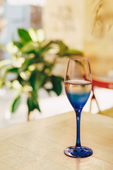 A glass of wine on the table. Blue glass