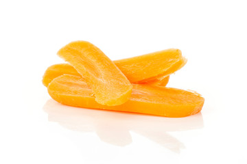 Group of three slices of peeled orange baby cut carrot isolated on white background