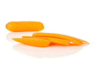 Group of one whole four slices of peeled orange baby cut carrot isolated on white background