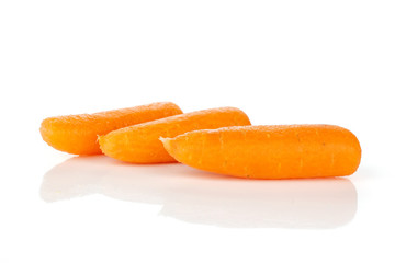 Group of three whole fresh peeled orange baby cut carrot isolated on white background