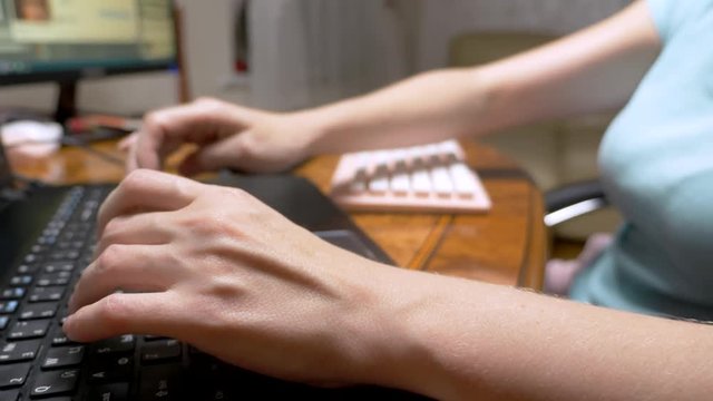 The concept of multitasking or cheating in social networks. One woman types simultaneously on three keyboards. hand closeup.