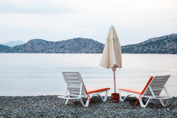 two chairs and umbrella on the beach