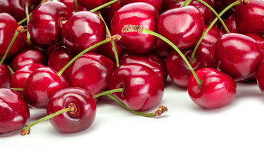 heap of red sweet cherries on white background