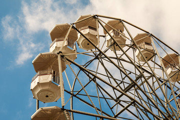 Low angle view of a white panoramic wheel against blue cloudy sky, Imperia, Liguria, Italy