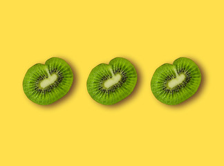 Three halves of sliced kiwi, with shadow.