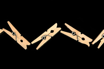 Group of wooden clothes pin in black background