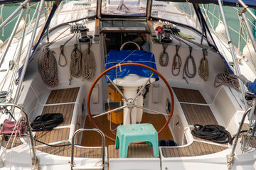 Close-up from above of a boat interior with the rudder and nautical ropes, Imperia, Liguria, Italy