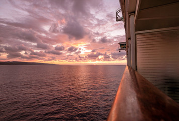 Cruise ship at sea with sun setting