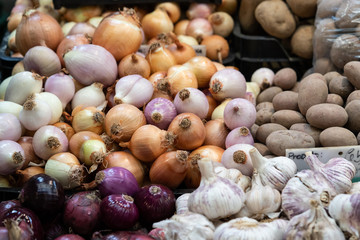Onions, potatoes and garlic for sale at local market