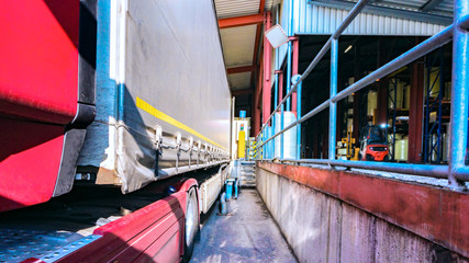 Cargo truck at warehouse building . the truck with the trailer on loading .