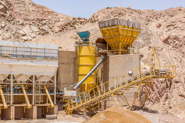 old iron tanks and production line of digging factory industrial object in Middle East desert sand...