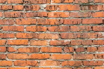 textured, expressive wall of red bricks