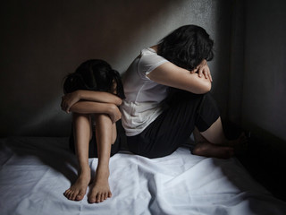 Traumatized woman and her daughter, Domestic family violence and aggression concept violence....