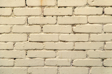 textured, expressive wall of light-colored bricks