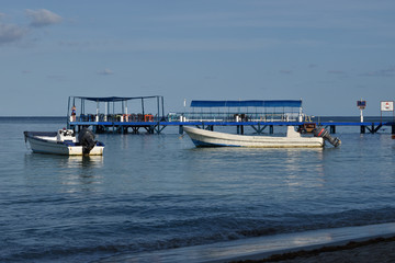 Blue sea, boats and dock