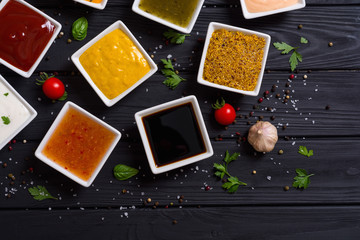 Set of different sauces in ceramic bowl
