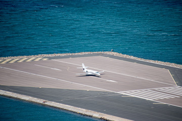 A private business jet about to take of from the Gibraltar Airport. The runway was built into the...