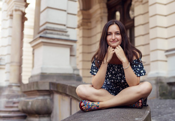 Brunette girl sitting in the old town