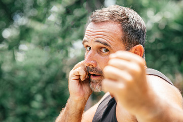 Play hard. Muscular man in black sportswear training outdoors. Copy space on the left side.