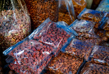 Almonds and cashew nuts in plastic bag at the market. Healthy food. High protein food for fitness...
