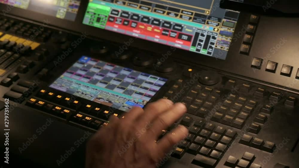 Poster hands using a control panel in a control room, during a live event. close up.