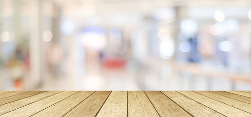 Wooden table, tabletop, desk over blur store with bokeh light background, Empty wooden shelf,...