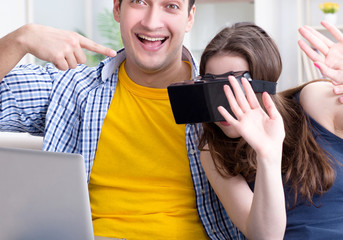 Young family playing games with virtual reality glasses