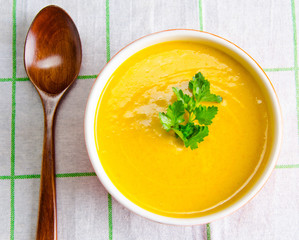 Carrot soup served on the table in bowl