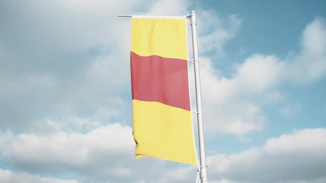 Medium Shot of the Flag of the historical territory of Baden in South Germany is waving in the wind, the blue sky in the background is partly covered in clouds.