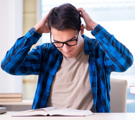 Student studying in the empty library with book preparing for ex