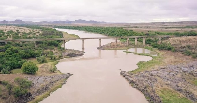 A concrete bridge over the mighty Orange River / Gariep River in the open bushveld of the Orange Free State of South Africa.