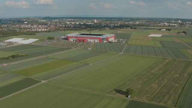 Drone / Aerial shot of the football stadium of the bundesliga team FSV Mainz 05 with field in the foreground on a sunny day, 30p