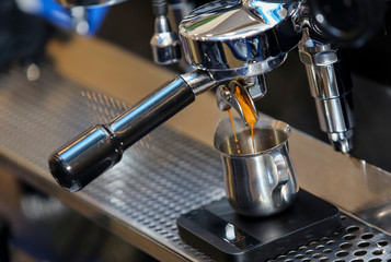 Espresso pouring from coffee machine