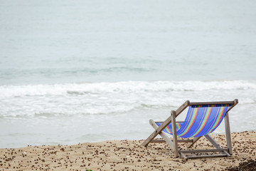 Beach chair on white sand with sea wave and sunny. Relaxing on the beach.