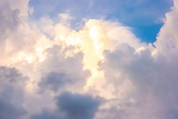 The clouds touched by the yellow light in the sky in the afternoon light before sunset. 