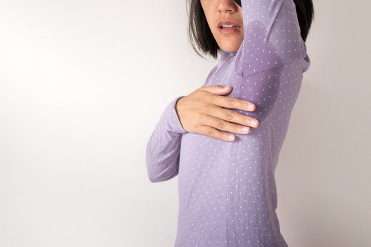 Asian Woman With Odor Sweating,Female Smelling Or Sniffing Her Armpit,Bad Smell,Copy Space For Text And White Background