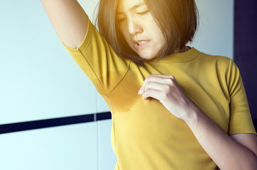 Asian women with odor sweating,Female smelling or sniffing her armpit,Bad smell