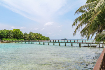Amazing island in the Maldives ,Beautiful turquoise waters and white sandy beach with  blue sky  background for holiday vacation .