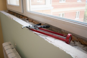 The building tool lies on the windowsill