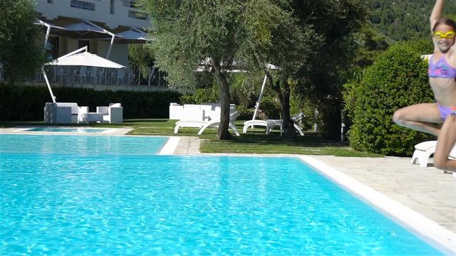 Little adorable girl in outdoor swimming pool