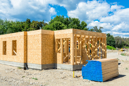 Wooden frame of new building with lumber materials prepared for construction