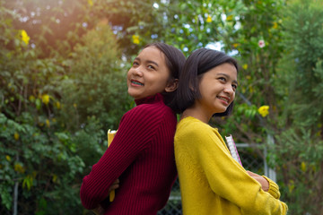 Portrait two asia young girl with happy emotion and Nature background.